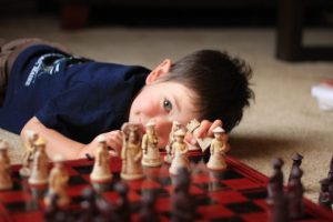 A boy looking to the chess board